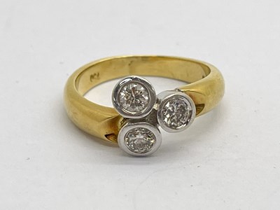 Lot 178 - A Three Stone Diamond Set Dress Ring, rubover...