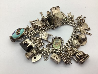 Lot 245 - A Curb Link Charm Bracelet, to heart shape...