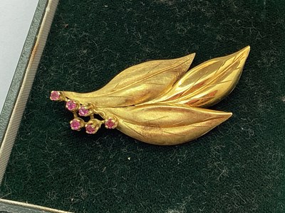 Lot 123 - An 18ct Gold Ruby Set Brooch, of foliage style,...