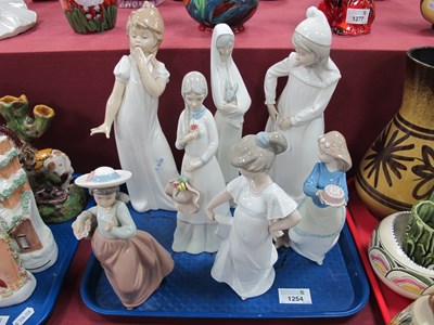 Lot 1254 - Nao Figurines, two in nightdresses 28cm high,...