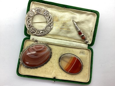 Lot 140 - A Victorian Banded Agate Oval Panel Brooch,...