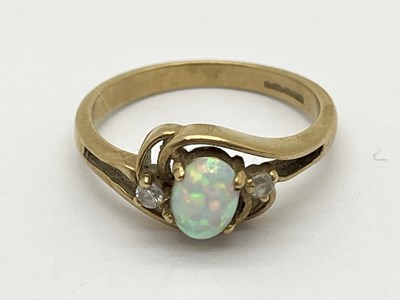 Lot 63 - A 9ct Gold Three Stone Ring, the oval cut opal...