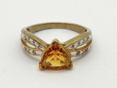 Lot 56 - A 9ct Gold Stone Set Dress Ring, between...