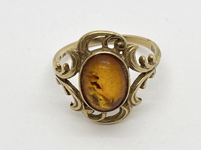 Lot 55 - A 9ct Gold Dress Ring, the amber coloured...