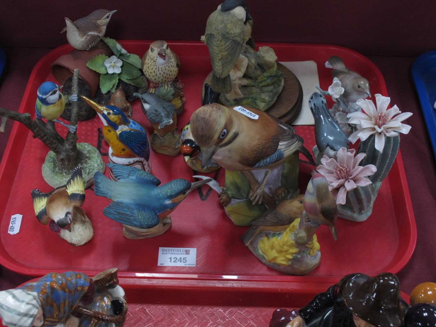 Lot 1245 - A collection of bird figurines to include...