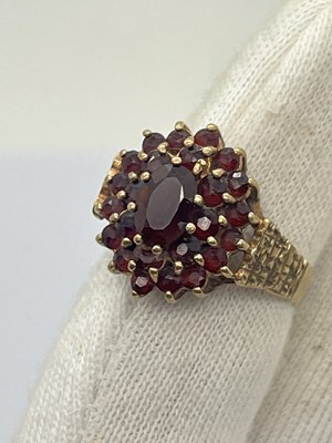 Lot 25 - A Garnet Cluster Dress Ring, claw set...