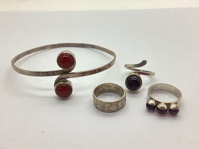 Lot 83 - A Stone Set Crossover Bangle, the collet set...