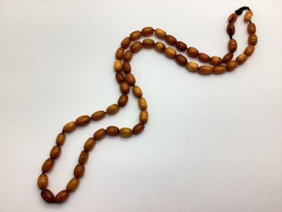 Lot 90 - A Graduated Amber Colour Single Strand Bead...