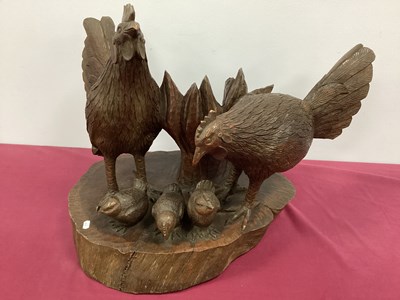 Lot 1152 - A Philippine Hardwood Carving of Two Chickens...