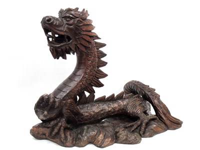 Lot 1151 - A Philippine Hardwood Carving of a Dragon, in...