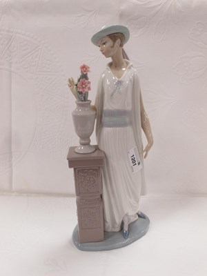 Lot 1201 - Lladro Lady Admiring Vase of Flowers, on a...