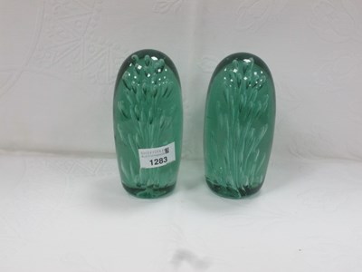 Lot 1283 - A pair of XIX Century green glass dumps with...