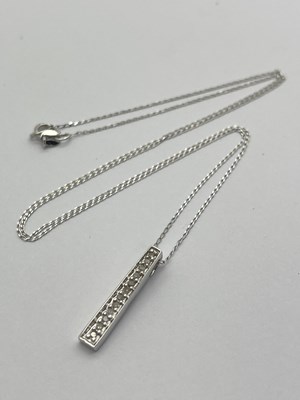 Lot 46 - A Modern 9ct White Gold Inset Line Pendant, on...