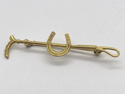 Lot 69 - A 9ct Gold Horseshoe and Crop Bar Brooch, pin...