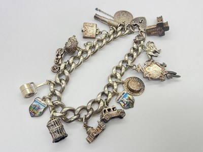 Lot 92 - A Hallmarked Sterling Silver Charm Bracelet,...