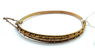 Lot 168 - An Edwardian 9ct Gold Hinged Bangle, engraved...