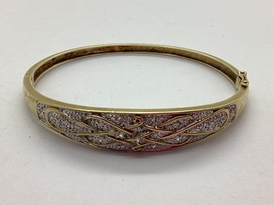 Lot 43 - A 9ct Gold Diamond Set Hinged Bangle, the...