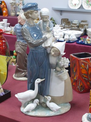 Lot 1284 - Lladro Figure Group, of a man holding a child,...