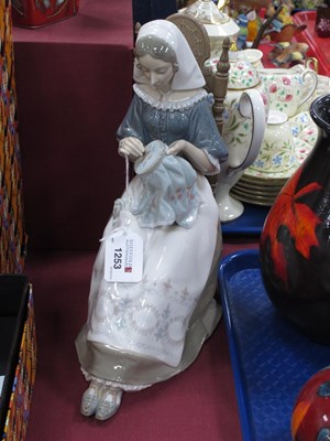 Lot 1253 - Lladro Figurine, of a seated lady sewing, 28cm...