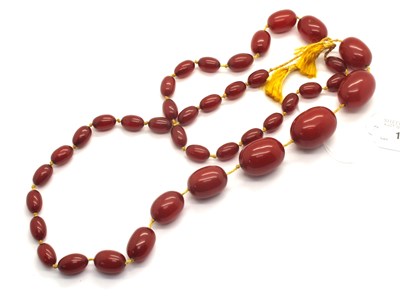 Lot 122 - A Single Strand Cherry Amber Coloured Bead...