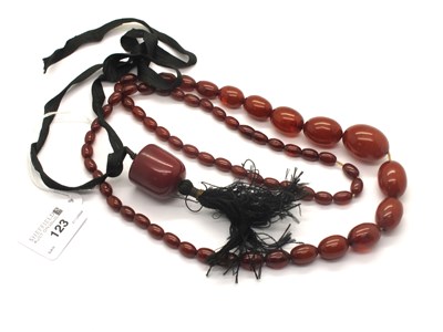 Lot 123 - A Single Strand Cherry Amber Coloured Bead...