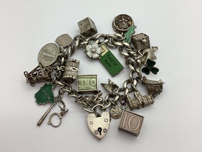 Lot 536 - A Curb Link Charm Bracelet, to heart shape...