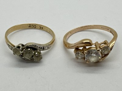 Lot 75 - A Three Stone Crossover Ring, the uniform band...