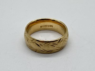 Lot 102 - A 9ct Gold Band Ring, of chased scroll design...