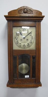 Lot 1125 - 1940s Oak Cased Wall Clock, with a silver dial,...