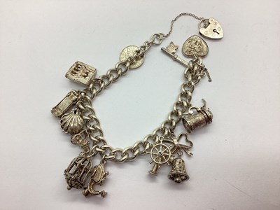 Lot 123 - A Chunky Curb Link Charm Bracelet, suspending...