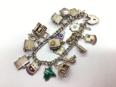 Lot 128 - A Chunky Curb Link Charm Bracelet, suspending...