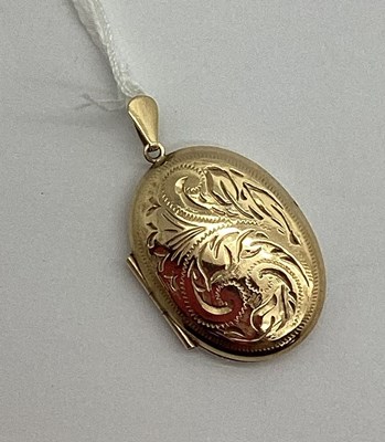 Lot 535 - A Modern 9ct Gold Oval Locket Pendant, leaf...