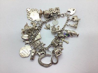 Lot 127 - A Chunky Curb Link Charm Bracelet, suspending...