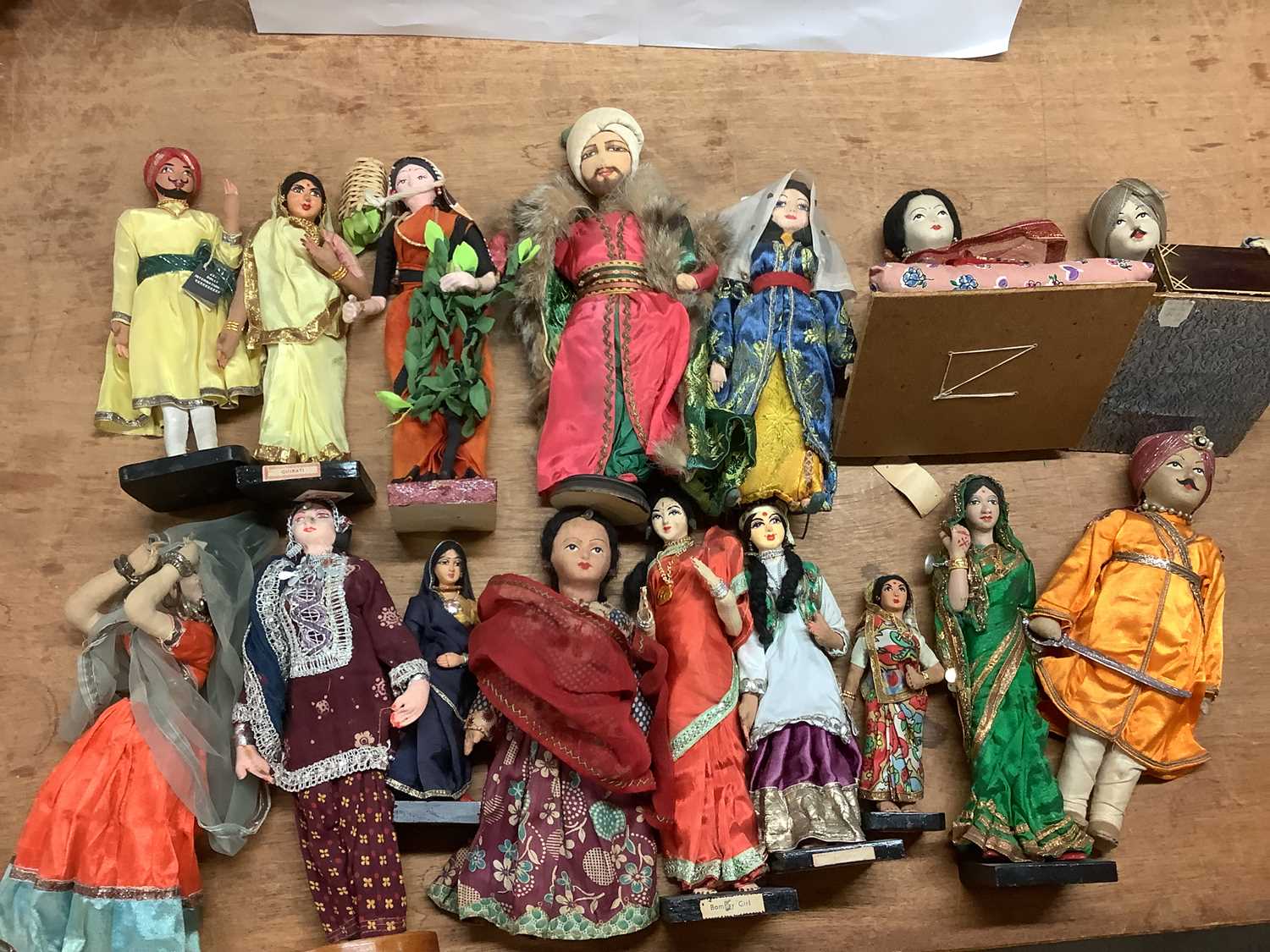 Lot 1419 - Fourteen Indian Costume Dolls, some on plinth...