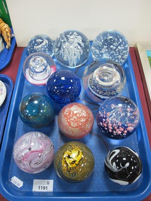 Lot 1191 - A collection of glass paperweights to include...