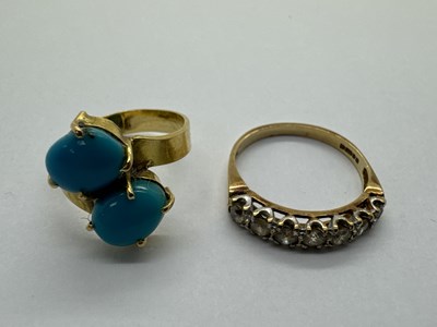 Lot 113 - A Two Stone Crossover Ring, the oval cabochon...