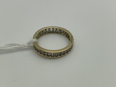 Lot 464 - A Full Eternity Style Ring, claw set...