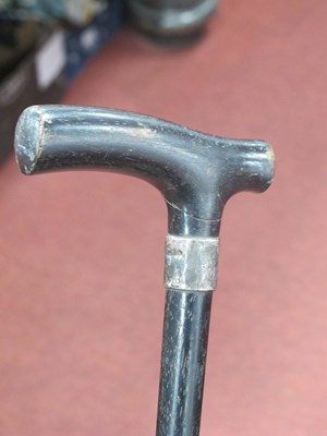 Lot 1276 - Ebonized Walking Cane with silver ferrule.