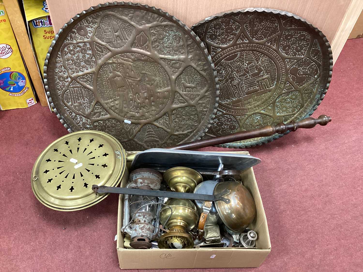 Lot 1121 - Two Embossed Brass Chargers, (one featuring...