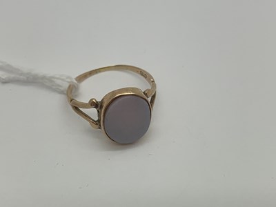 Lot 485 - A Hardstone Set Ring, the oval panel collet...