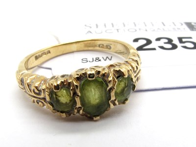 Lot 235 - A 9ct Gold Vintage Three Stone Ring, the oval...