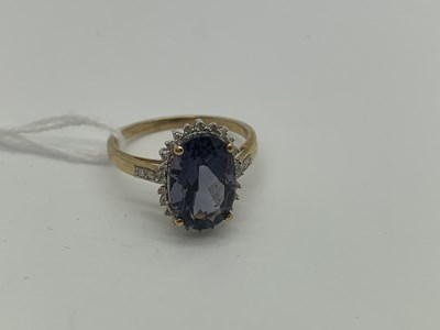 Lot 488 - A Modern Cluster Ring, oval four claw centre...