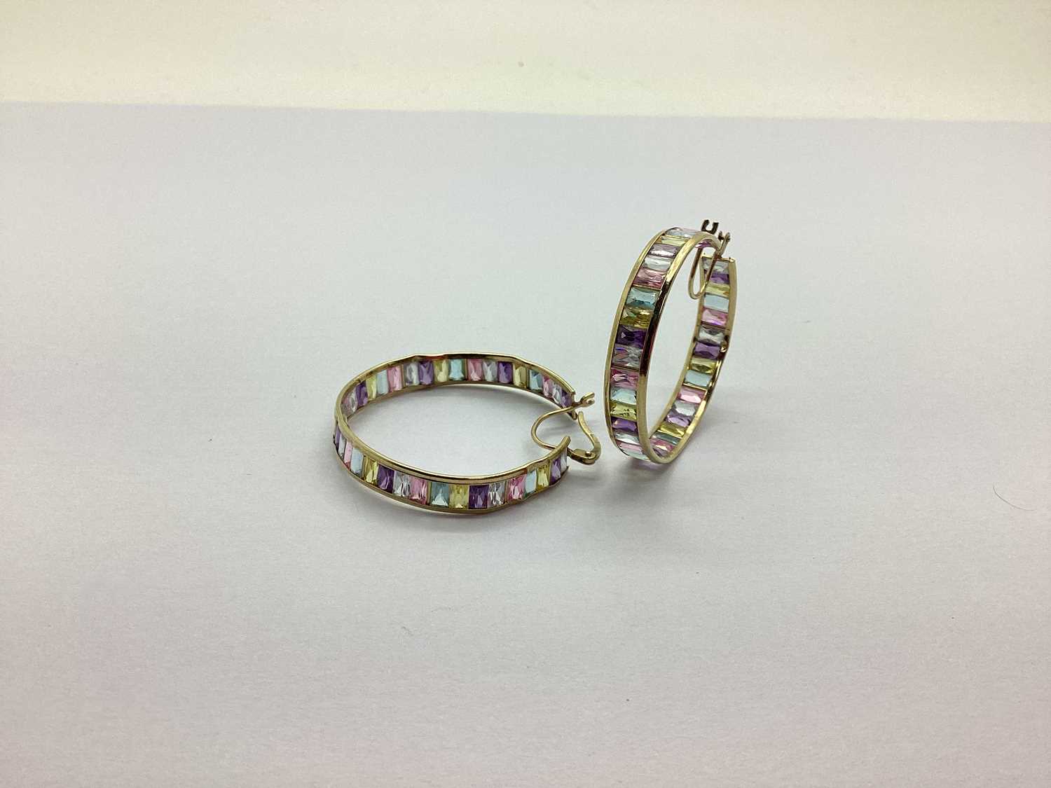 Lot 188 - A Pair Of Ornate Hoop Earrings, channel set...