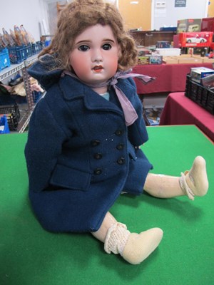Lot 678 - An S.8.B.J Doll, curly hair, blue overcoat,...