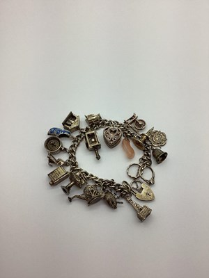 Lot 450 - A Curb Link Charm Bracelet, to heart shape...