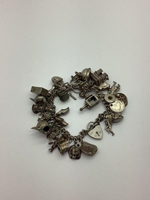 Lot 436 - A Curb Link Charm Bracelet, to heart shape...