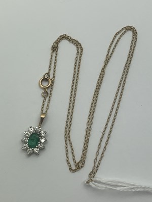 Lot 539 - A Modern Emerald and CZ Cluster Pendant, claw...