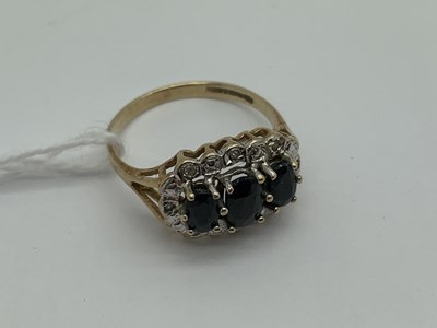 Lot 505 - A 9ct Gold Sapphire and Diamond Ring, oval...