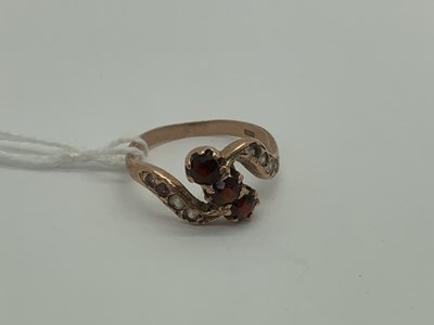 Lot 506 - A 9ct Rose Gold Garnet Three Stone Ring, of...