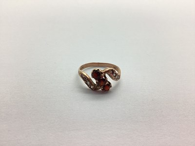 Lot 219 - A 9ct Rose Gold Garnet Three Stone Ring, of...